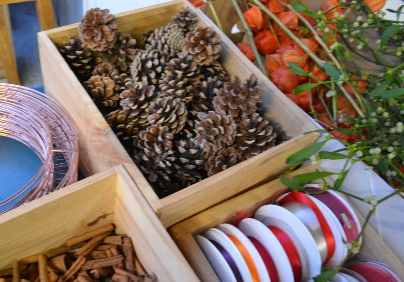 A selection of materials used to decorate a handmade Christmas wreath
